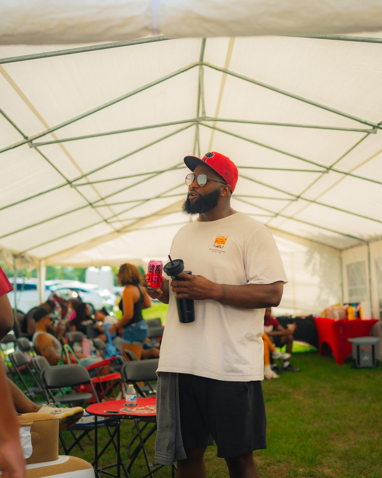 Lot 82 game-day tailgate gathering under the tent